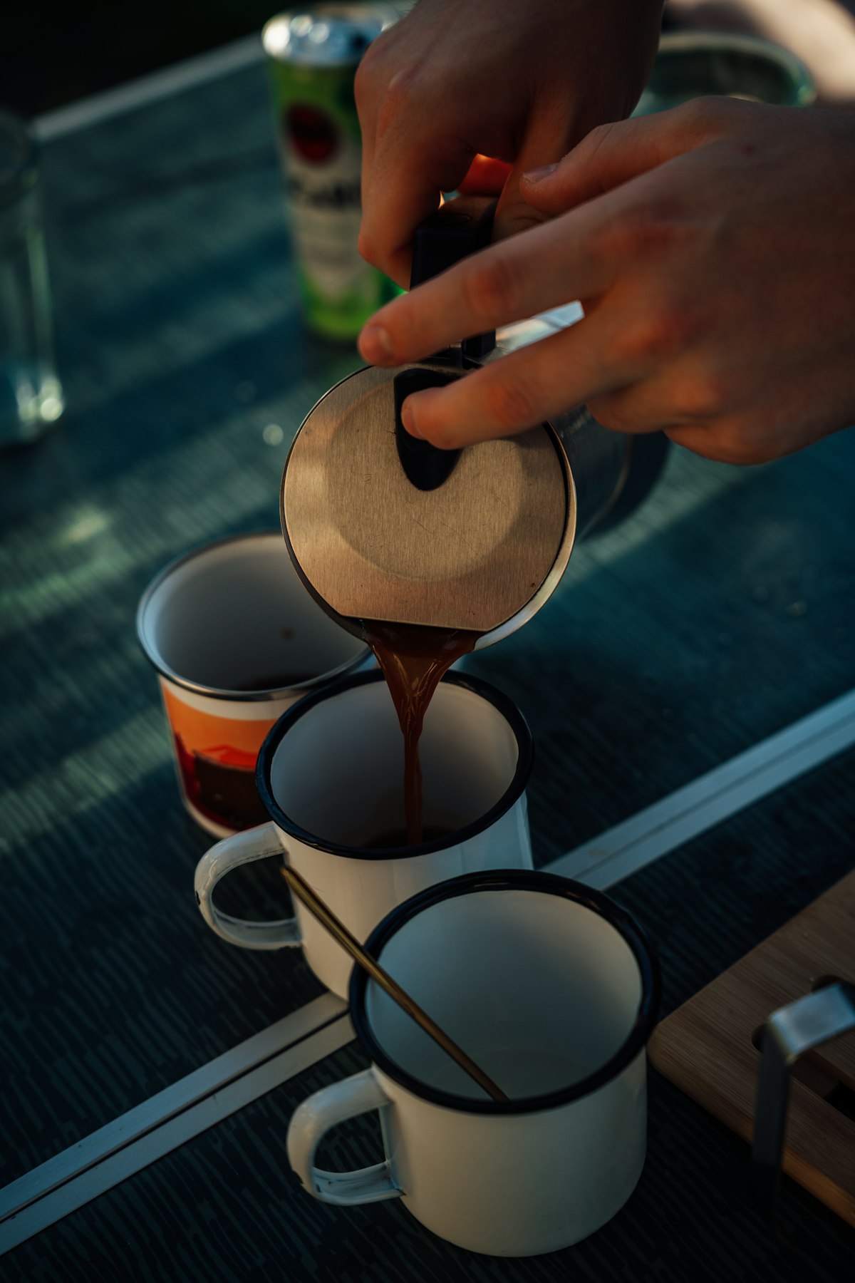 Coffee poured from a moka pot during a camping morning near Como, Italy