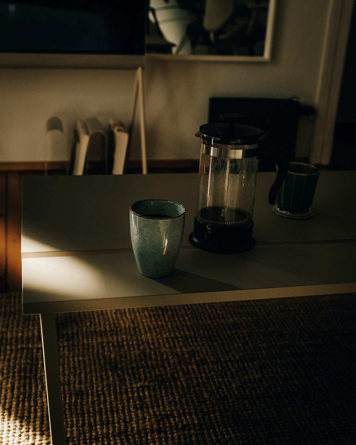 French press and a mug on a table